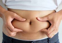 Obesity’s Hidden Organ Overhaul person pinching belly fat at the waist