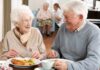 Skip Meat, Speed Up Frailty? Two seniors smiling while eating a meal together at a table
