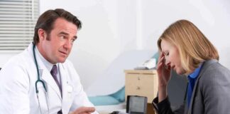 doctor talking to concerned woman in office